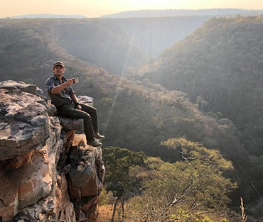 Niall Mcann having a cuppa on a rocky outcrop